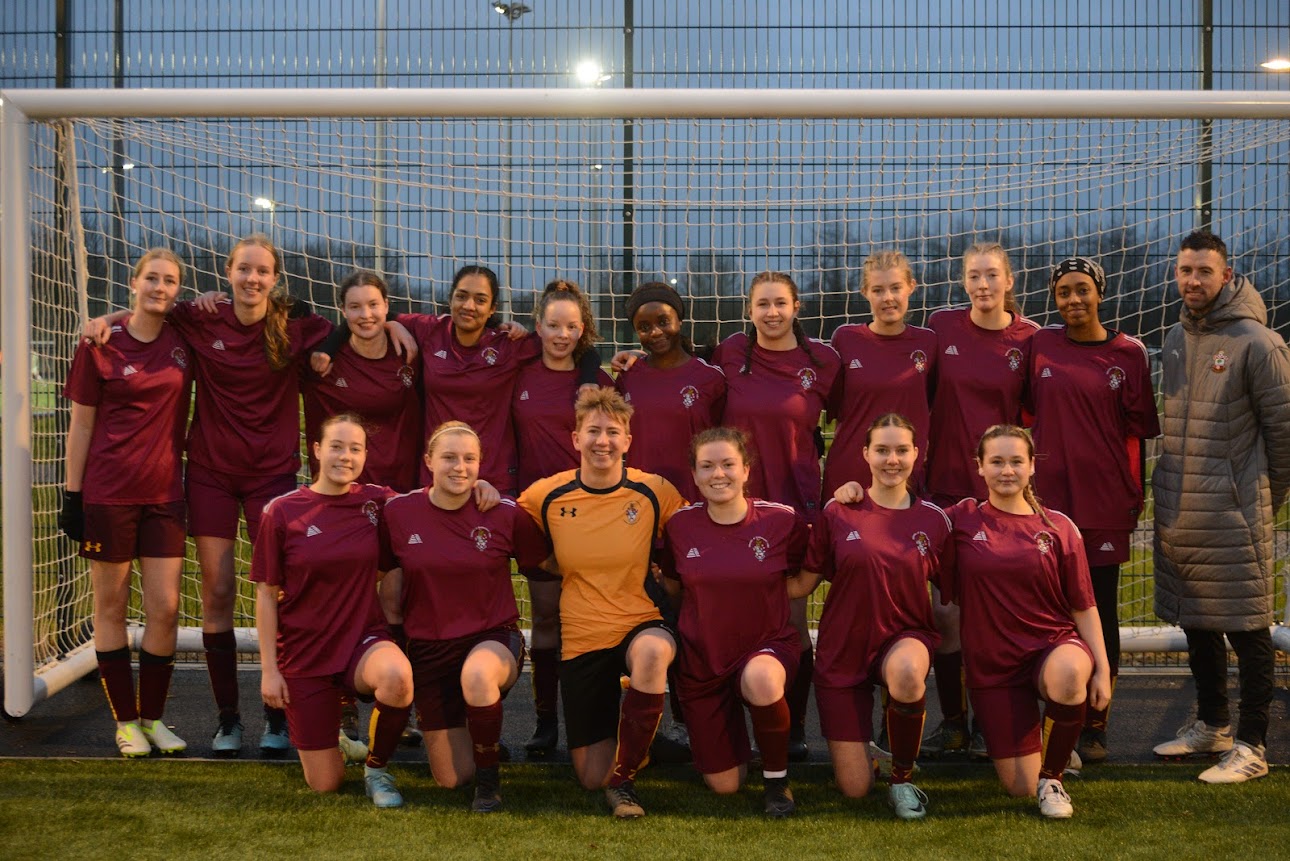 The squad lined up in front of the goal at dusk