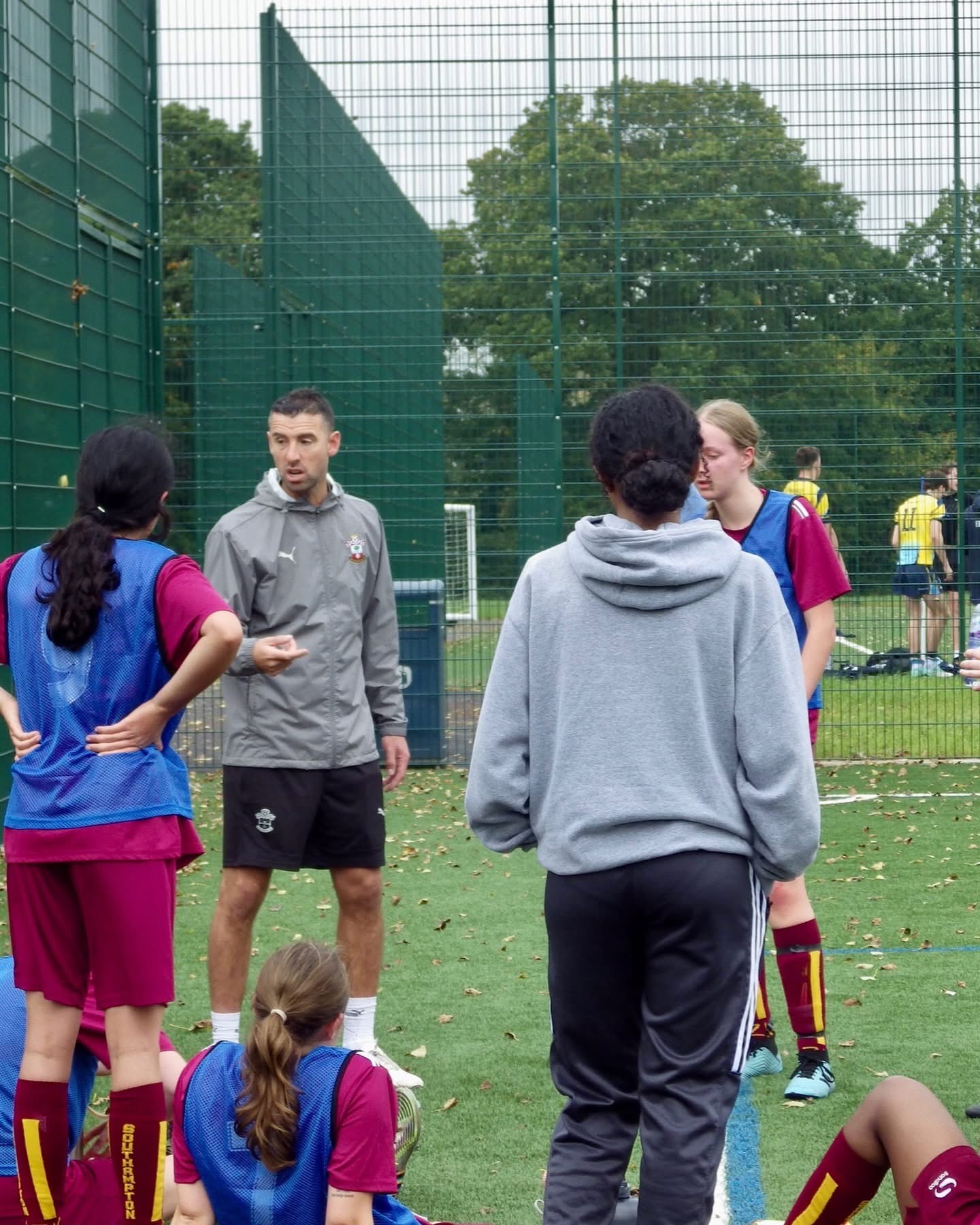 Dave talking through coaching points with players on the pitch