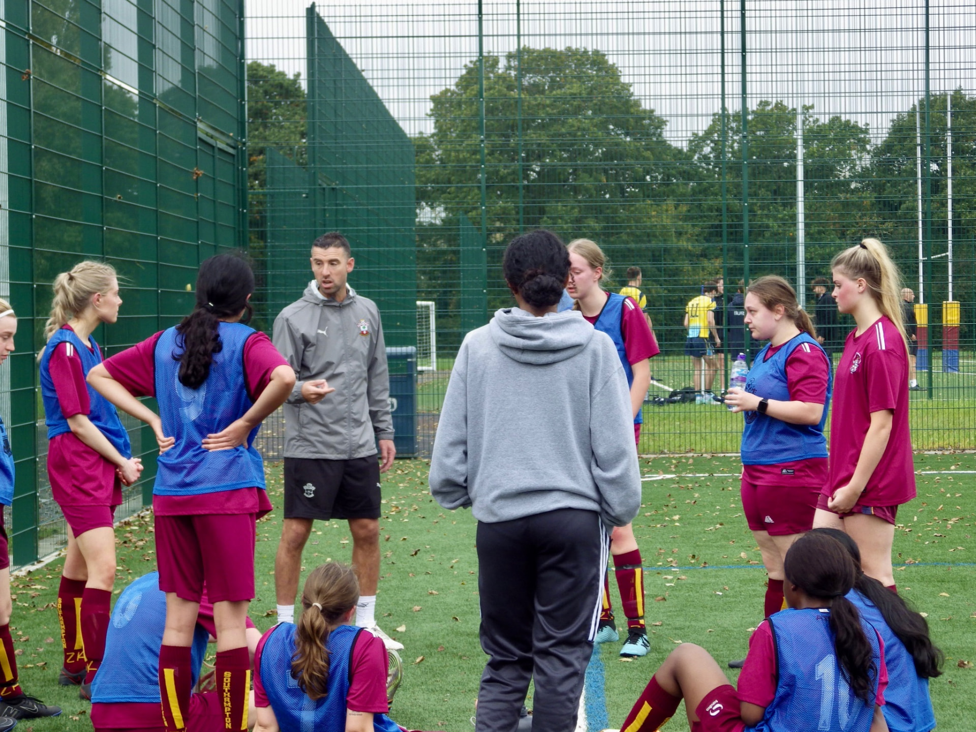 Dave briefing the squad in a circle on the pitch