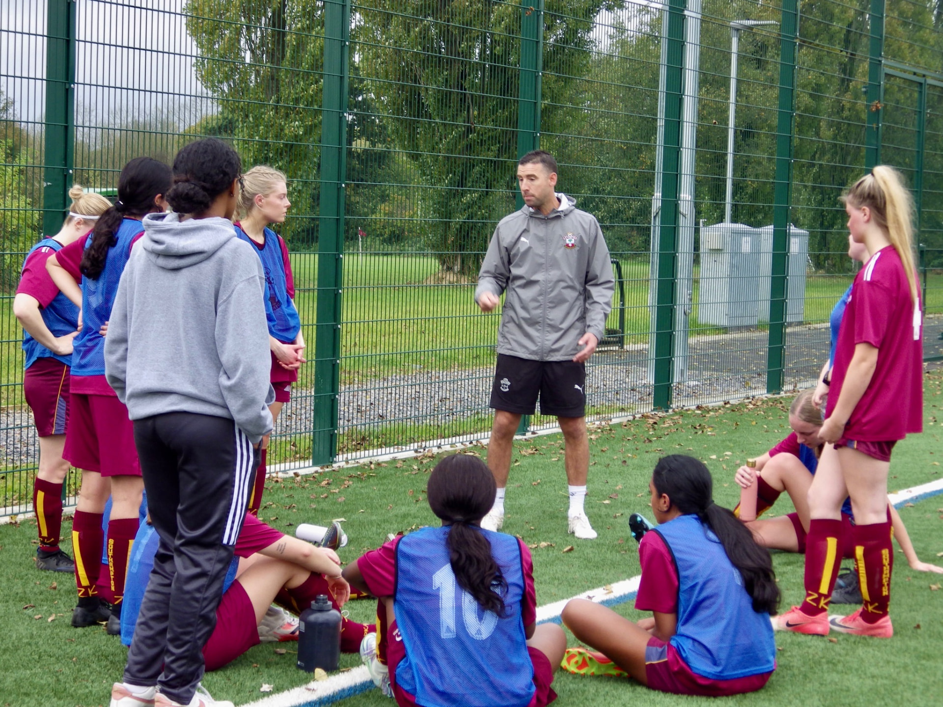 Dave coaching women footballers on the pitch